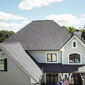 Indianapolis Roofers – Willow 20 High view of a stucco home with many gables and new shingle roof.