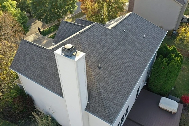 Aerial view of completed asphalt shingle roof repair with chimney flashing – Robert Stevens Roofing, Zionsville IN