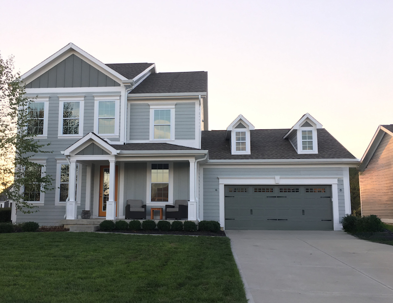 Zionsville House Gray two-story home with dark asphalt shingle roof and dormers in Zionsville, Indiana by Robert Stevens Roofing