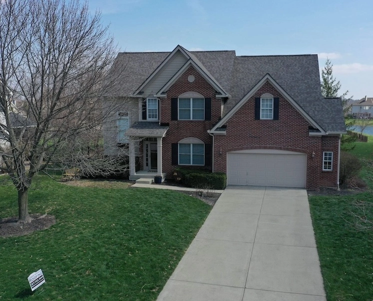 Roof Replacement on Zionsville, IN home Gray two-story home with dark asphalt shingle roof and dormers in Zionsville, Indiana by Robert Stevens Roofing
