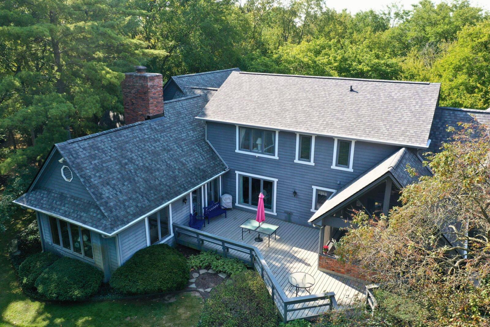 Aerial view of a completed roof replacement on a large two-story home in Avon Indiana featuring charcoal gray architectural shingles by Robert Stevens Roofing