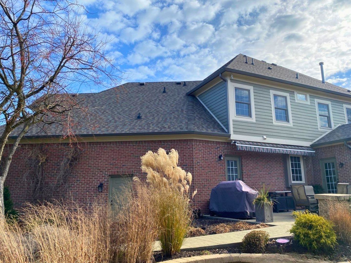 Aerial view of a completed roof replacement on a large two-story home in Avon Indiana featuring charcoal gray architectural shingles by Robert Stevens Roofing