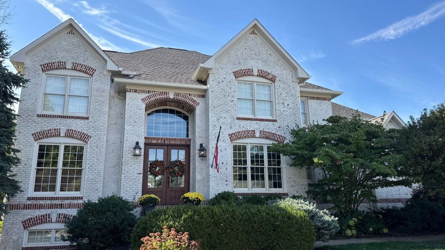 White brick home roof replacement by Carmel Roofing Company, Robert Stevens Roofing Completed roof installation on a white brick home in Carmel, IN by Robert Stevens Roofing