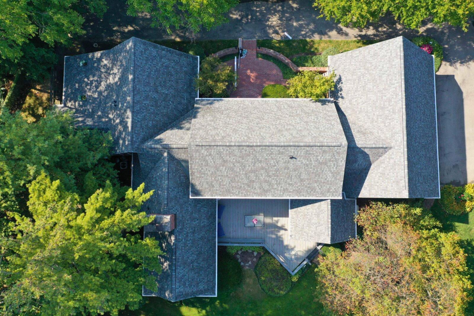 Aerial view of a completed complex roof replacement on a large Carmel home by Robert Stevens Roofing