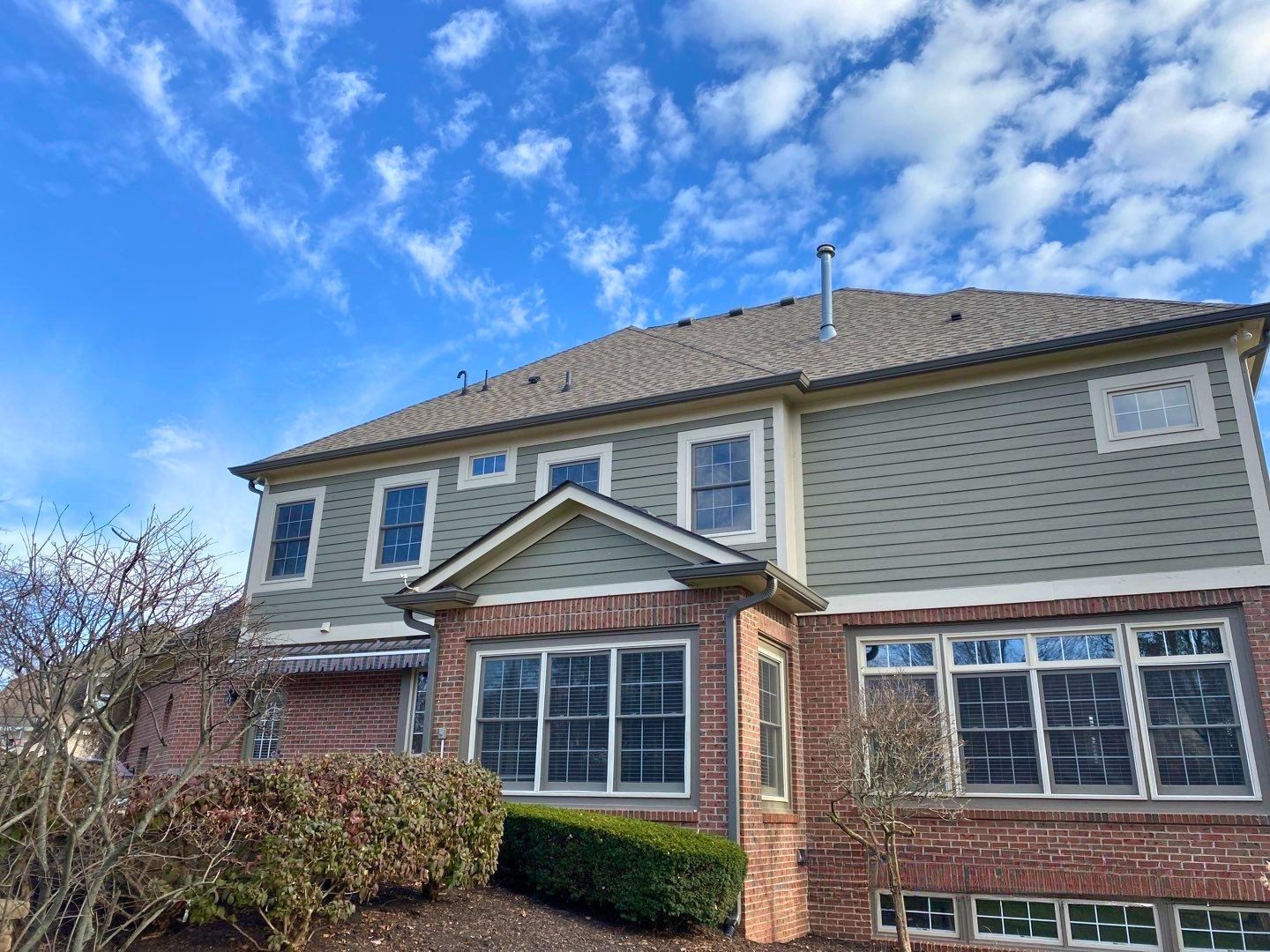 Aerial view of a completed roof replacement on a large two-story home in Avon Indiana featuring charcoal gray architectural shingles by Robert Stevens Roofing