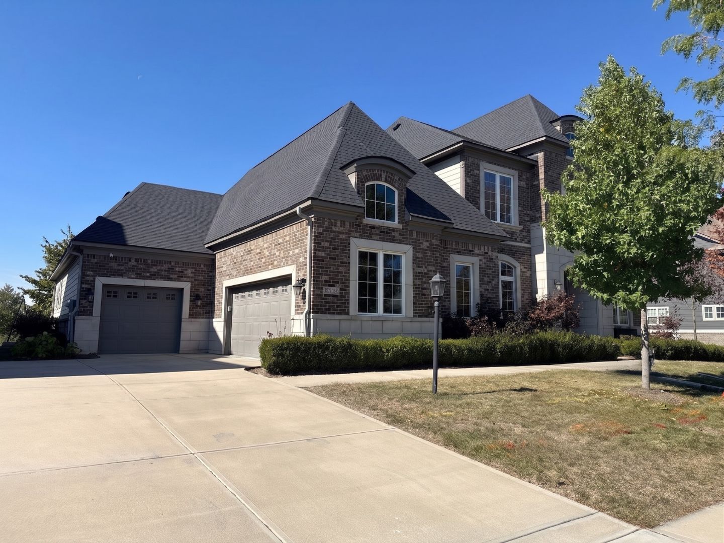 Completed dark charcoal roof on a luxury brick home in Carmel, IN by Robert Stevens Roofing