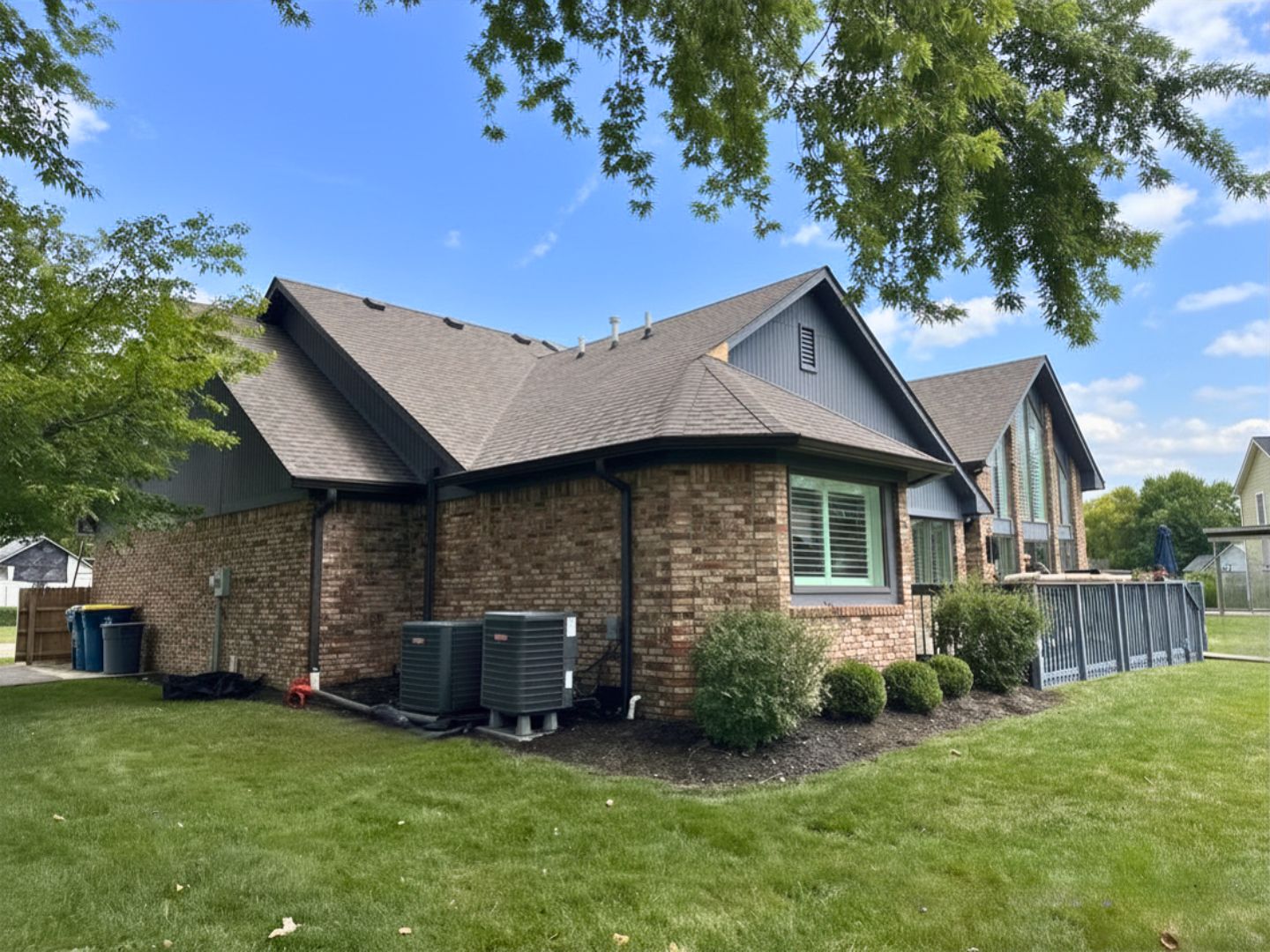 Carmel Roofing — Multi-Section Roof Replacement — Robert Stevens Roofing Completed multi-section roof replacement on a brick home in Carmel, IN by Robert Stevens Roofing
