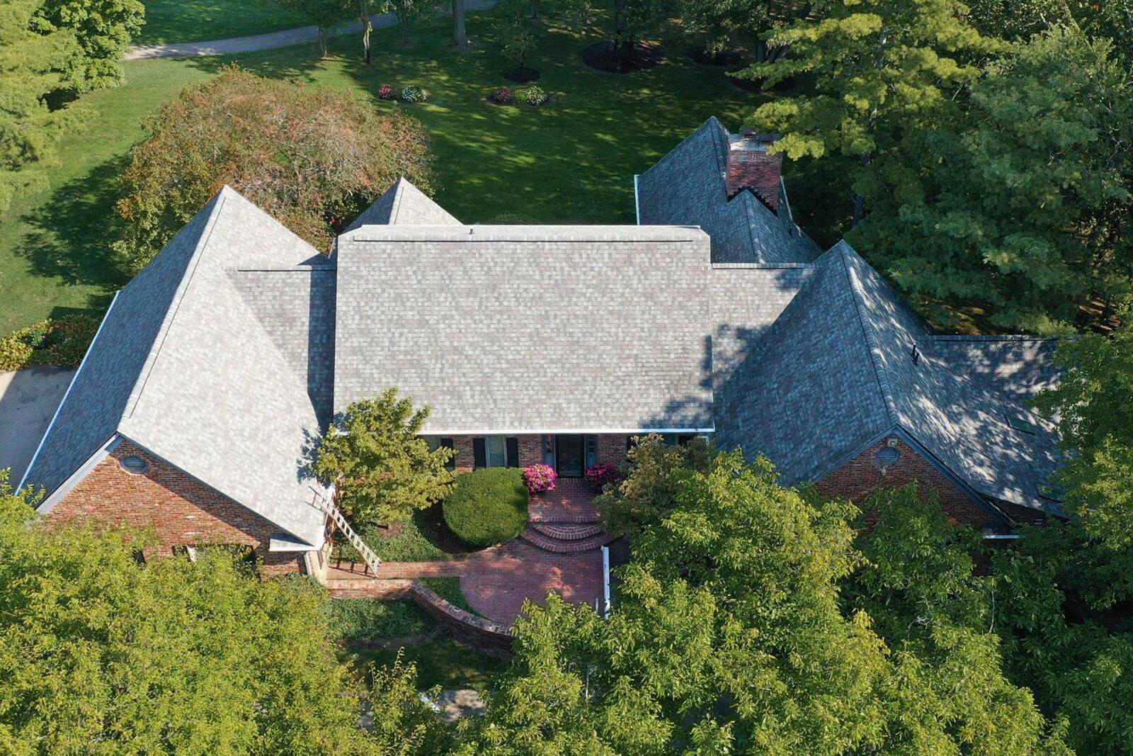 Carmel Storm Damage Roof Replacement — Robert Stevens Roofing Completed roof replacement on a large brick home in Carmel, IN by Robert Stevens Roofing following storm damage