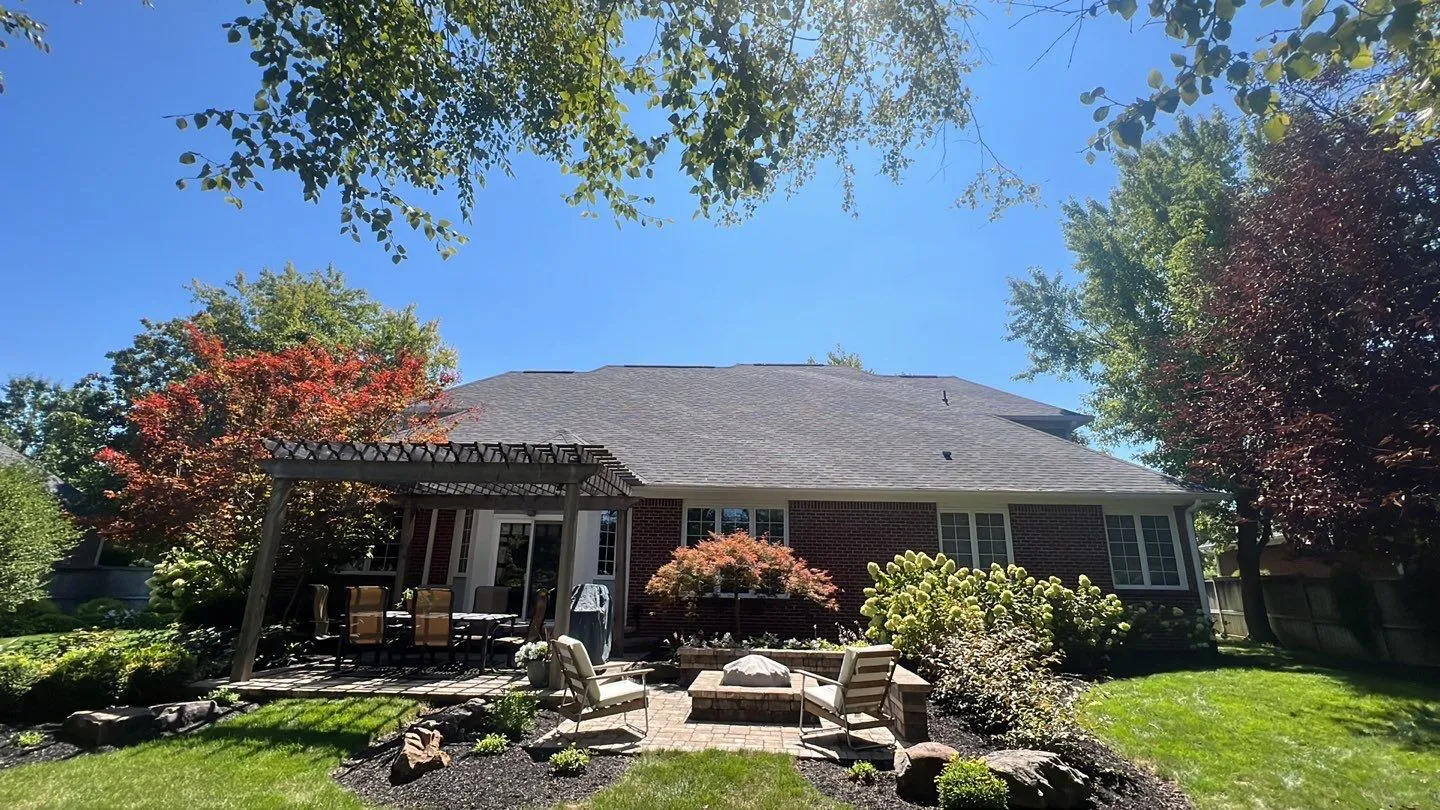 Westfield roofing project | Brick ranch home roof replacement Aerial view of a completed roof replacement on a large two-story home in Avon Indiana featuring charcoal gray architectural shingles by Robert Stevens Roofing
